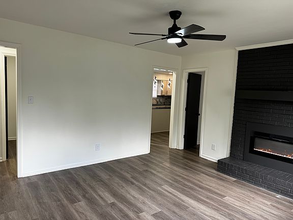 Living room with hallway, kitchen , and dining room entry