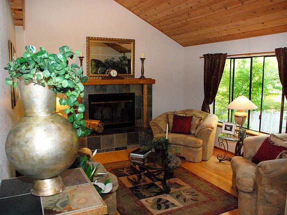 Living Room w/wood ceiling, flooring and wood burning fireplace.