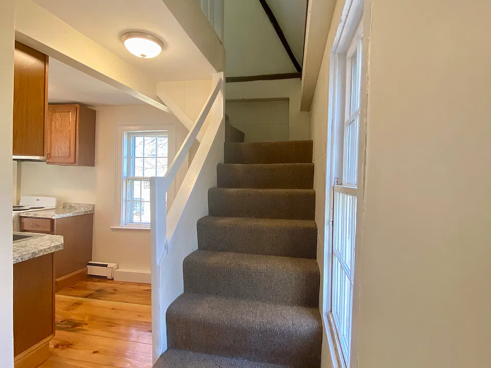 Stairs to office/storage space with walk through to bedroom