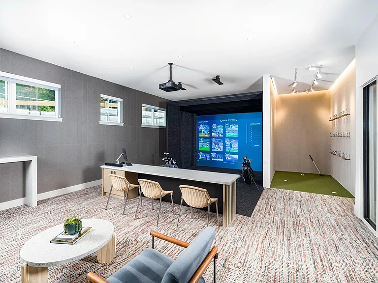 Perfect your swing year-round in the golf simulator lounge, complete with a putting green and comfortable seating for spectators.
