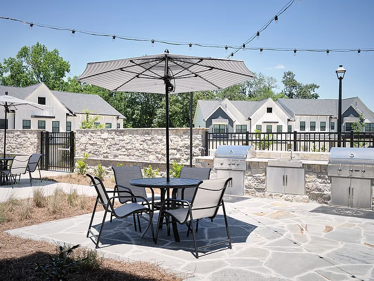 Inviting patio setup with umbrella-covered seating ideal for gatherings or quiet moments.