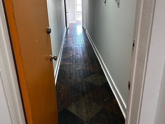 Into the apartment-- opens to a long hallway.