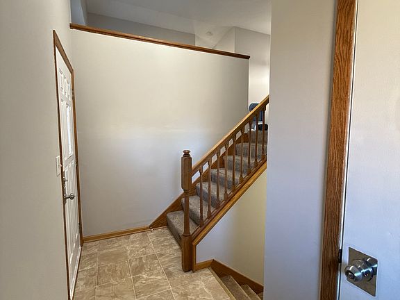 Bright entryway with updated lighting and easy access to both levels.