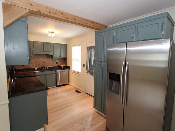 Updated kitchen with stainless appliances, exposed wooden be
