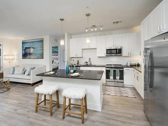 Open-Concept Living and Kitchen Area with Sleek White Cabinetry