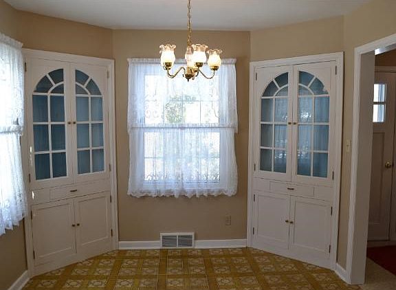 The formal dining room features corner built in cabinets and large windows. These windows used to view Dutch Lake.