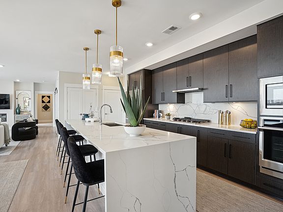 The modern kitchen includes granite countertops and stainless steel appliances.