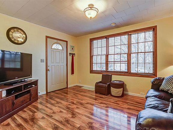 Living room with triple wood windows bring in lots of natural light