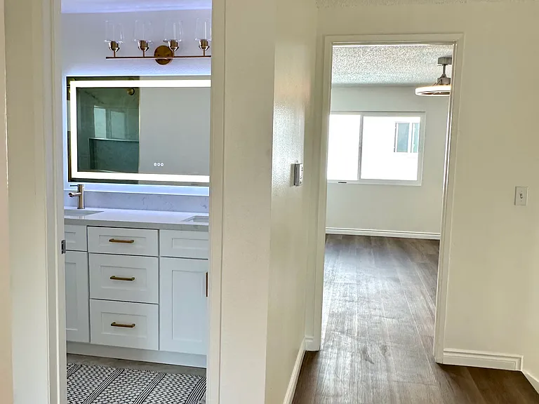 Hallway on second floor showing hallway bathroom and master bedroom entrance