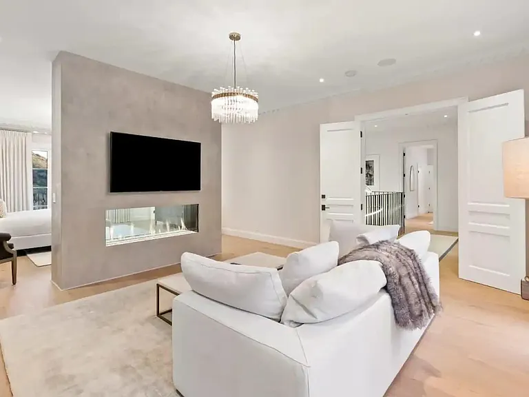 Curl up in the master bedroom with a good book or movie next to this dual sided fireplace.