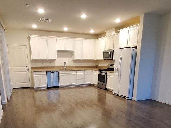 Beautiful entrance to Family Room Kitchen Combo! 1/2 bath, closet and slider to Private Patio.