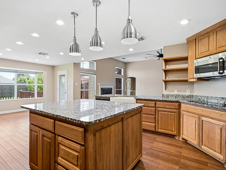 Big kitchen and granite island into breakfast nook