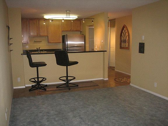 View from living room into entry and kitchen
