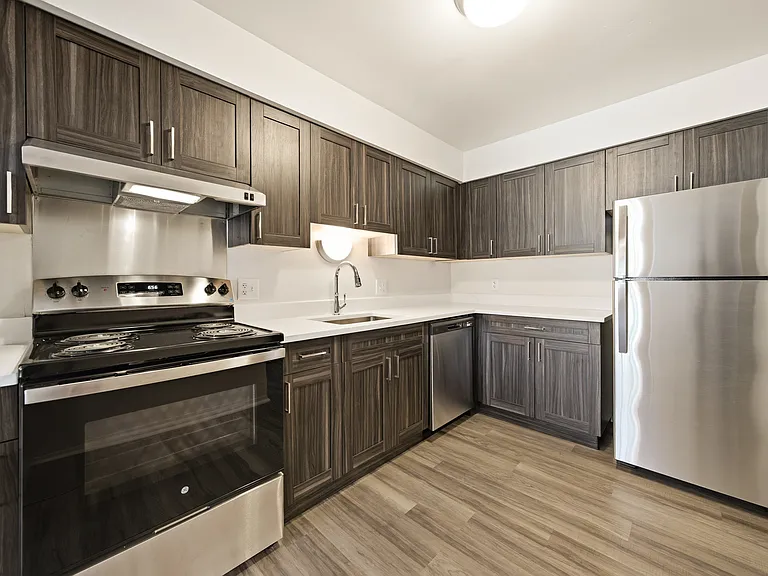 Modern kitchen with stainless steel appliances at Franklin River Apartments in Southfield, MI