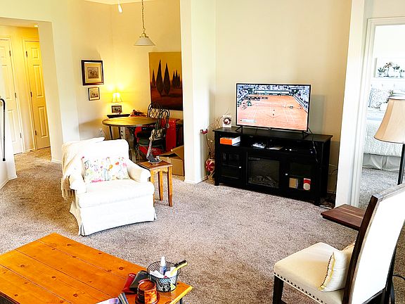 Living Room Furnished Looking toward Kitchen and Dining Nook to Left with Bedroom toward the Right