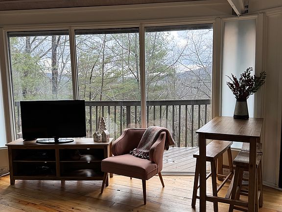 Living area with panoramic seasonal mountain views.