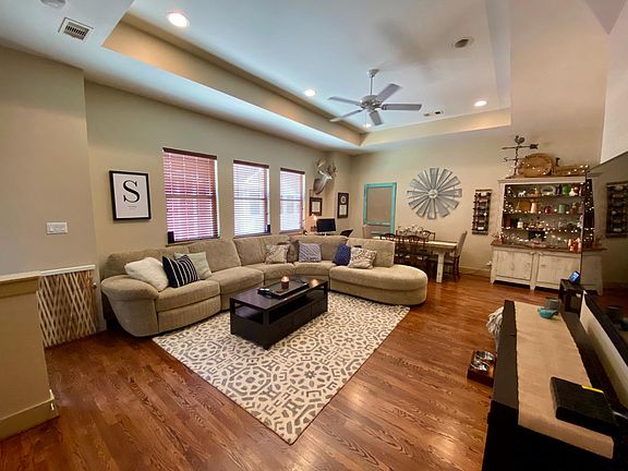 Open concept living room/dining room with enough space for a desk in the corner to work from home.