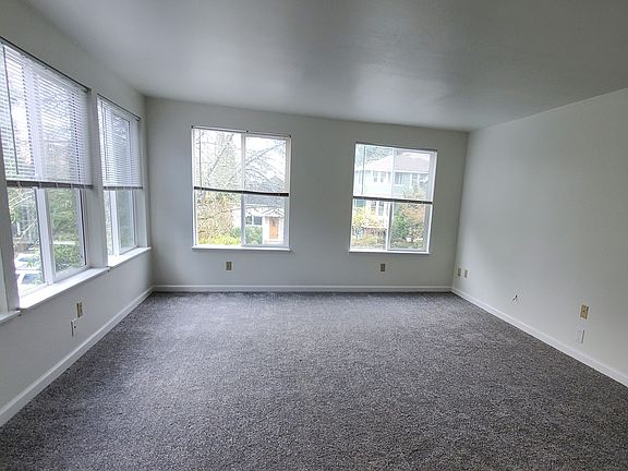 Bright, spacious living room. New carpet throughout house, newly painted interior.