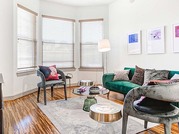 Griffis Uptown apartment living room with wood style flooring.
