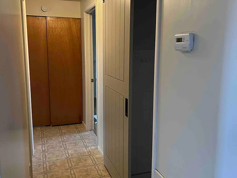 front hall barn door to bath 1