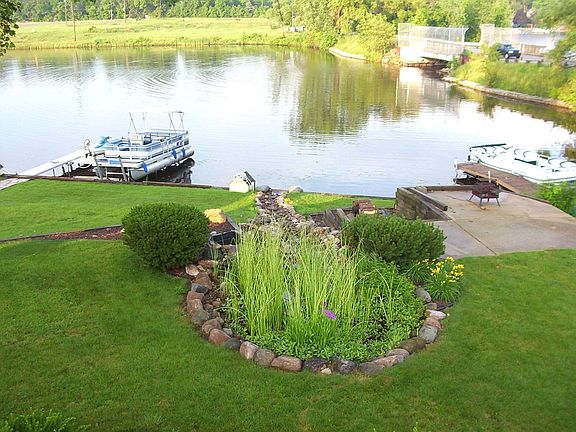 Back yard from upper deck showing water garden, rock stream, and landscaping