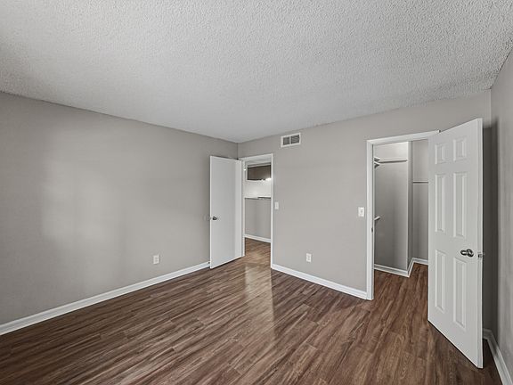 Bright bedroom in the one-bedroom apartment with updated flooring