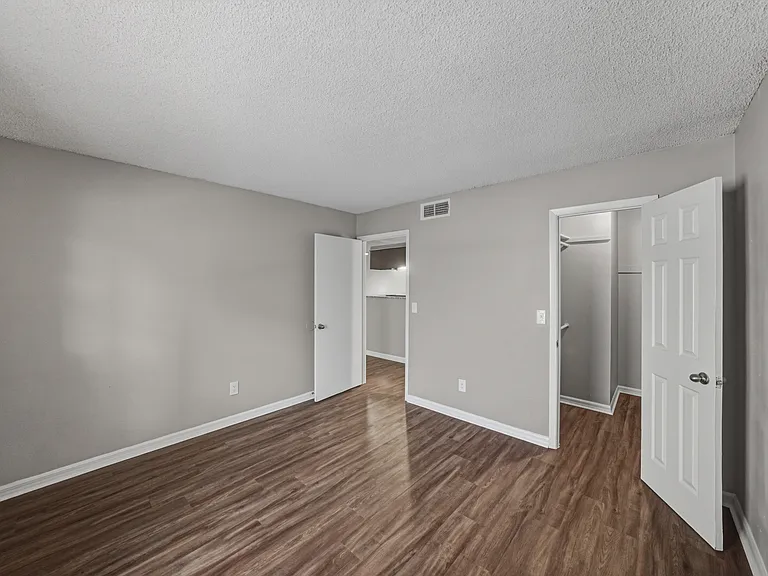 Bright bedroom in the one-bedroom apartment with updated flooring