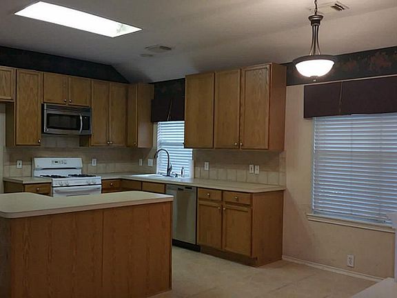 Kitchen with island showing the great lighting with the window.
