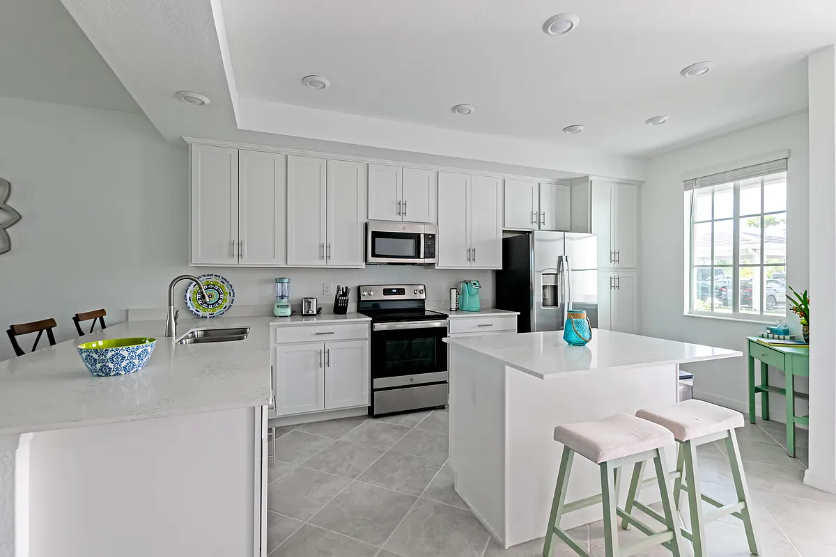 Beautiful, open kitchen stocked with all of the pots, pans, plates, and utensils you need to prepare meals. - 12240 Wellen Golf St #105