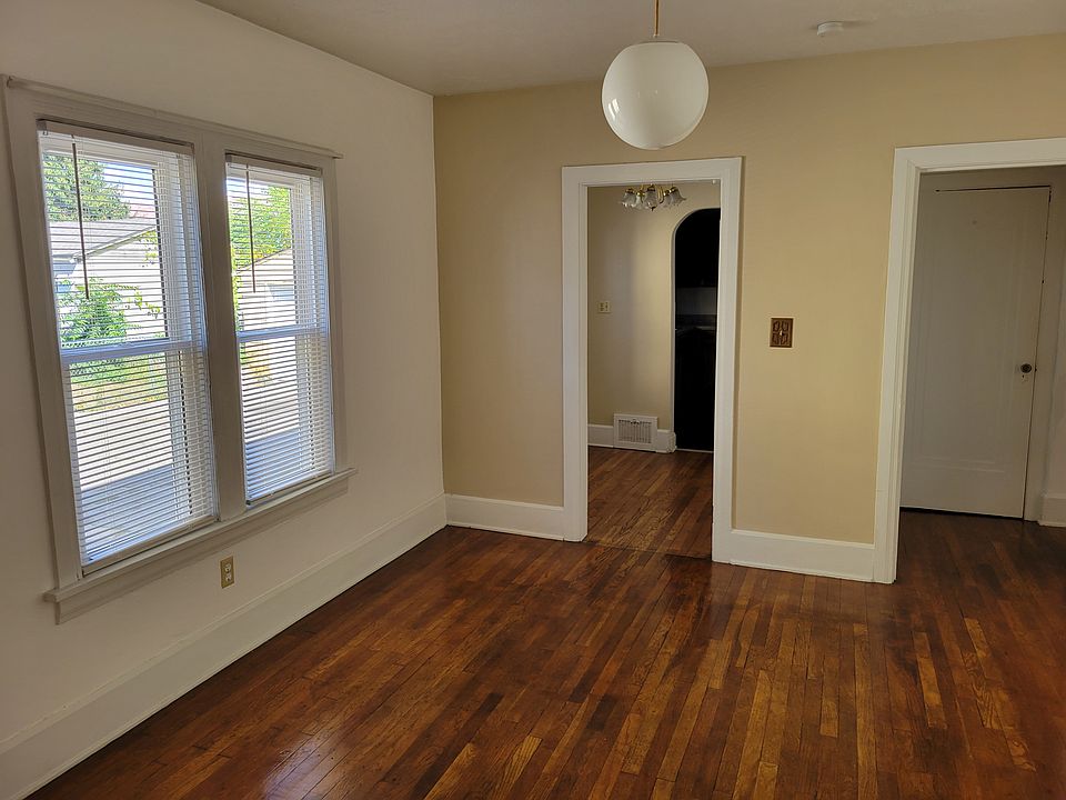 Dining room leading to breakfast nook and hallway to bathroom and bedrooms and new windows.