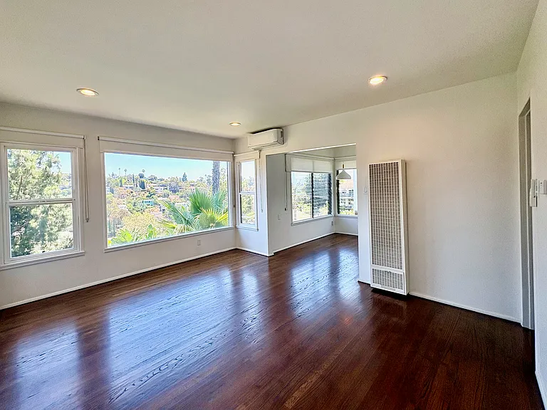 A dramatic wall of picture windows fills the living room with natural light.