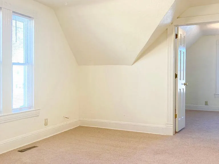 Living room with brand new carpet.
