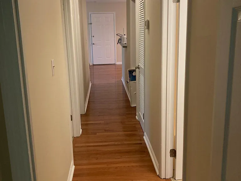 Hardwood floors throughout living, dining, and hallway.