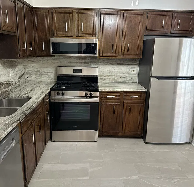 Beautiful kitchen with granite countertops and custom cabinets with new oven and dishwasher