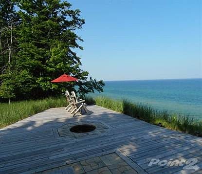 Expansive lakeside deck of wood & stone inlays beckons for morning coffee or sunset relaxation.