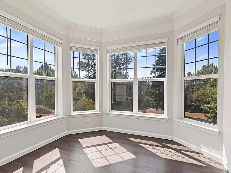 Expansive windows create a beautifully sunlit living space