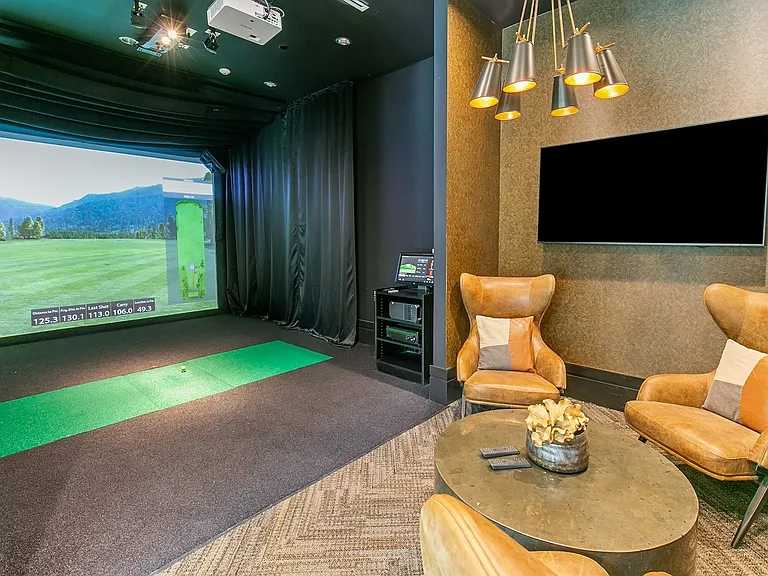 Tee off anytime in this cozy golf simulator lounge_perfect for practice or play, rain or shine.