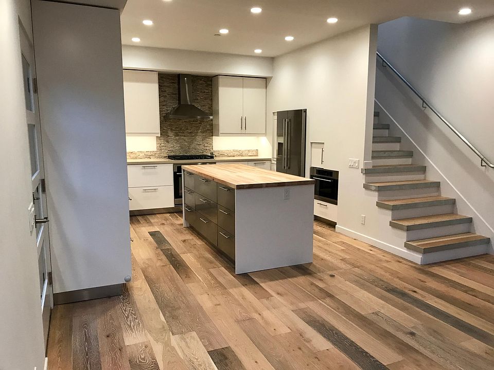 kitchen with microwave, gas cooktop, oven, stainless fridge
