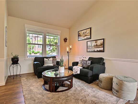 High ceilings lend air to this bright living room