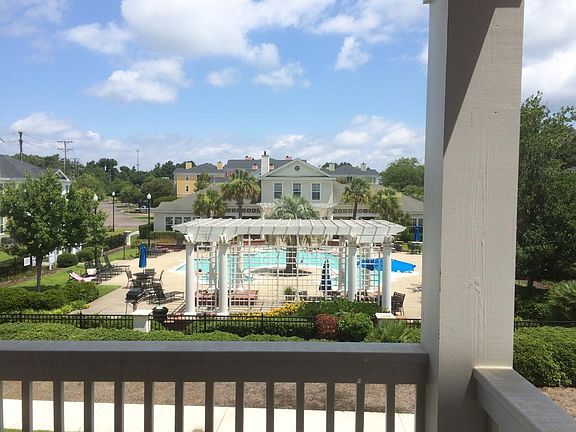 Pool, gazebo, gas grills and clubhouse from condo building