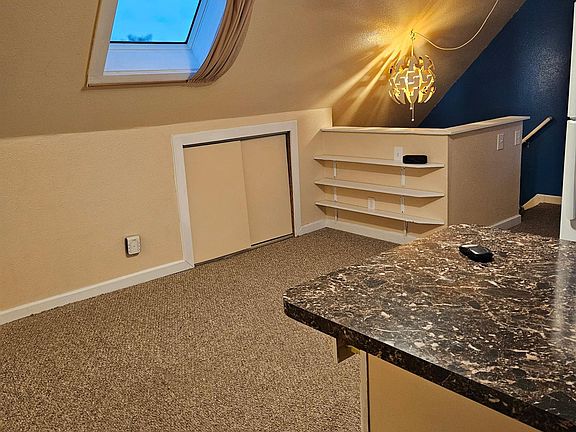 Living room, skylite and built in shelves.