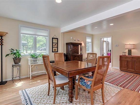 Lovely Dining Room with Hardwood Flooring and Recessed Lighting