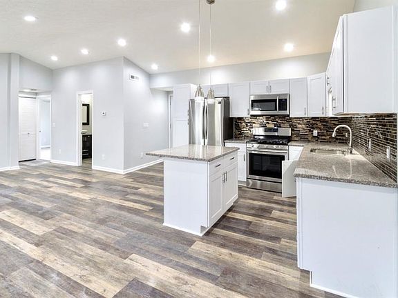 Absolutely stunning open concept kitchen and great room!  NEW stainless steel appliances, cabinets, granite countertops, backsplash, and vinyl life proof flooring!