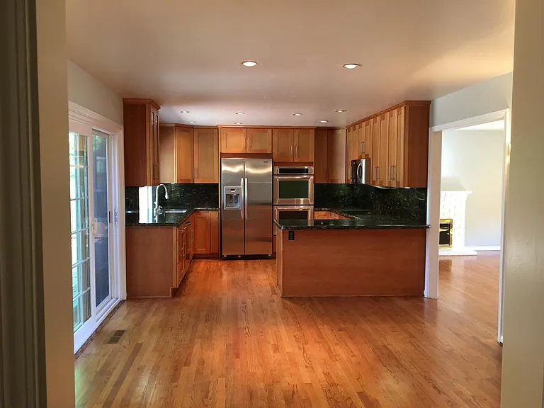 Standing in the hallway, looking at the dining room and kitc