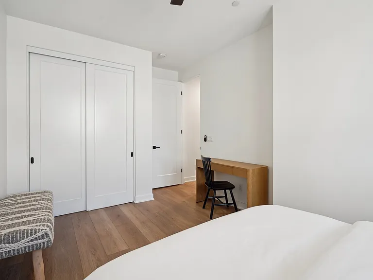 Bedroom two features a desk and a reach-in closet.