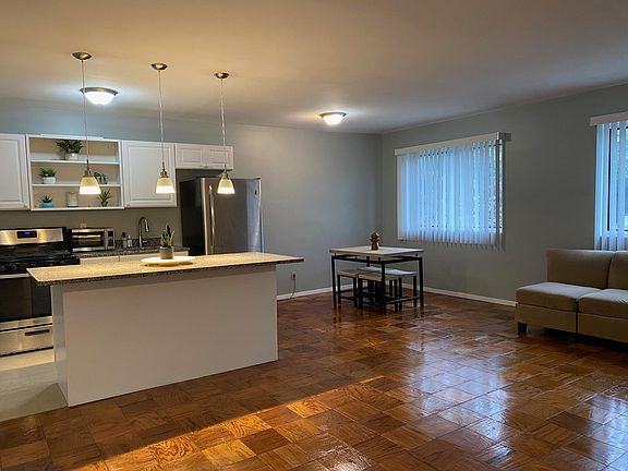 Kitchen with granite island and plenty of cabinets open living/dining/kitchen