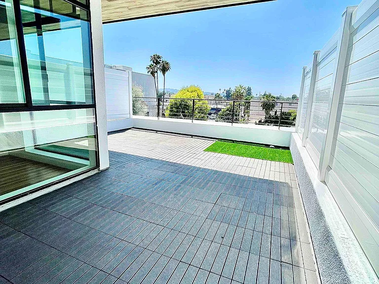 Private rooftop patio with decking and pet friendly synthetic turf. Shaded cantilever with dimmable led lighting. Sunset views.