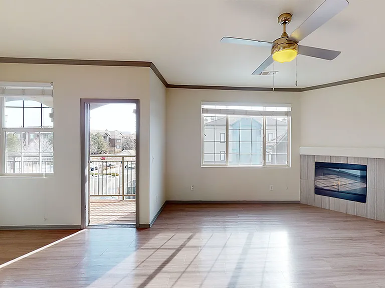 Apartment dining and living room with wood-style flooring.
