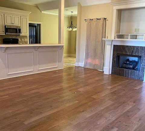 View of Open Family Room w/Fireplace (gas logs) Counter to left in Kitchen (Perfect for bar stools)