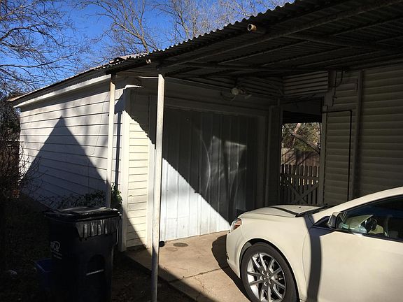 view of storage bldg and carport